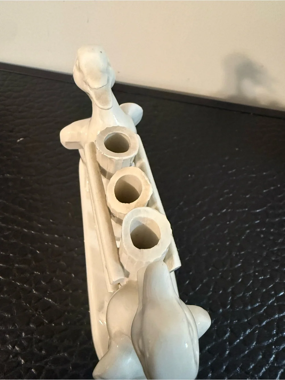 vintage ceramic toothbrush holder two ducks flanking a fence-like structure.